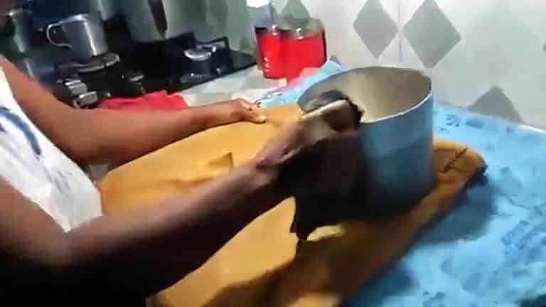 Madre cubana tiene que planchar el uniforme de su hijo con un jarro de metal calentado al fuego (+Video)